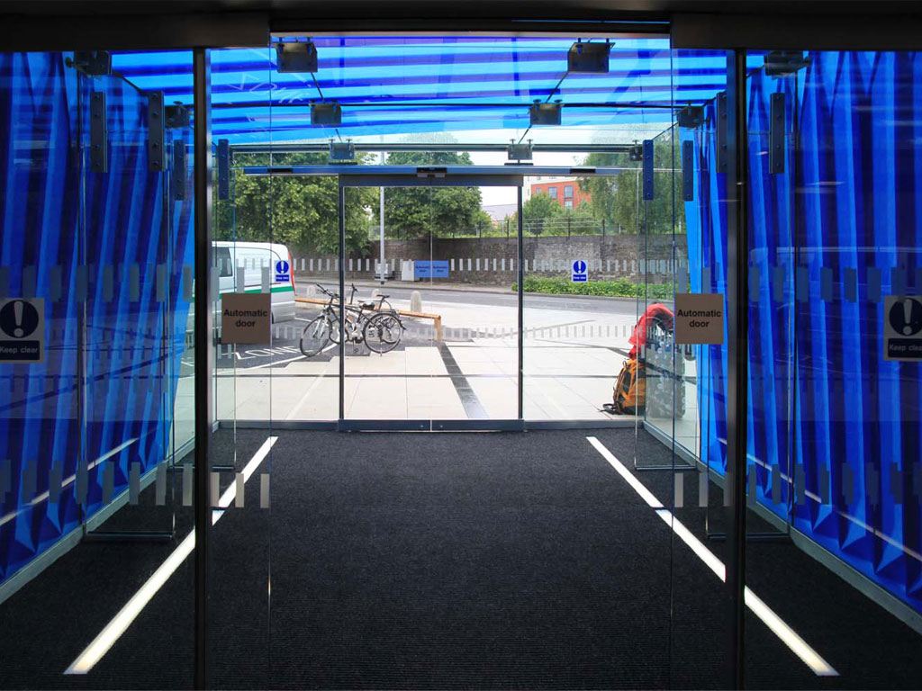 <i><b>Image:</b></i> <i>Fold</i>, a screen-printed enamel application to the glass cube entrance way of @Loudoun Square, Anna Heinrich & Leon Palmer, 2012